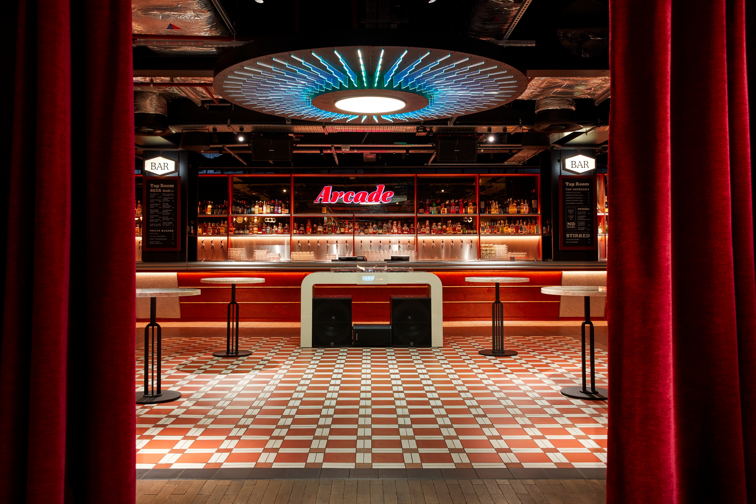 Full Venue Hire Arcade Battersea: vibrant event space with stylish bar for networking.