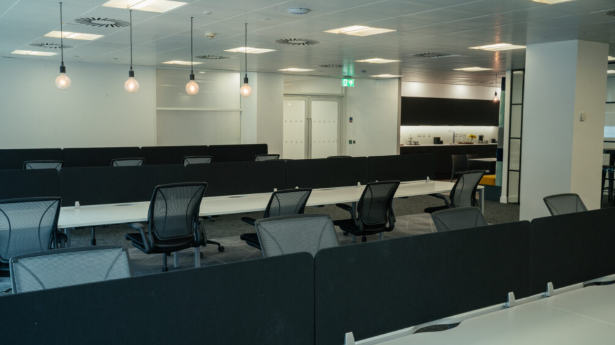 Modern open office space with adjustable workstations for corporate events and workshops.