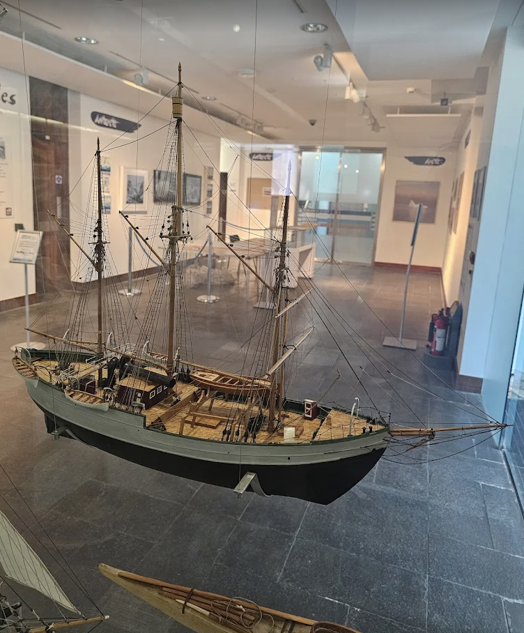 "Scott Polar Museum venue hire with ship model, ideal for maritime events and exhibitions."