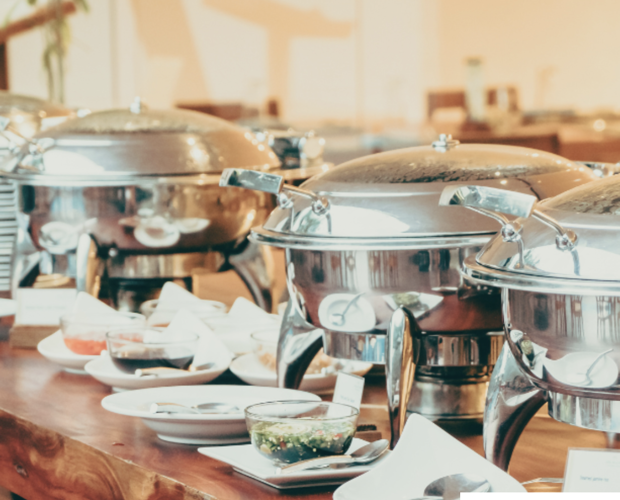 Elegant buffet setup with polished chafing dishes at Rivenhall Garden venue hire.