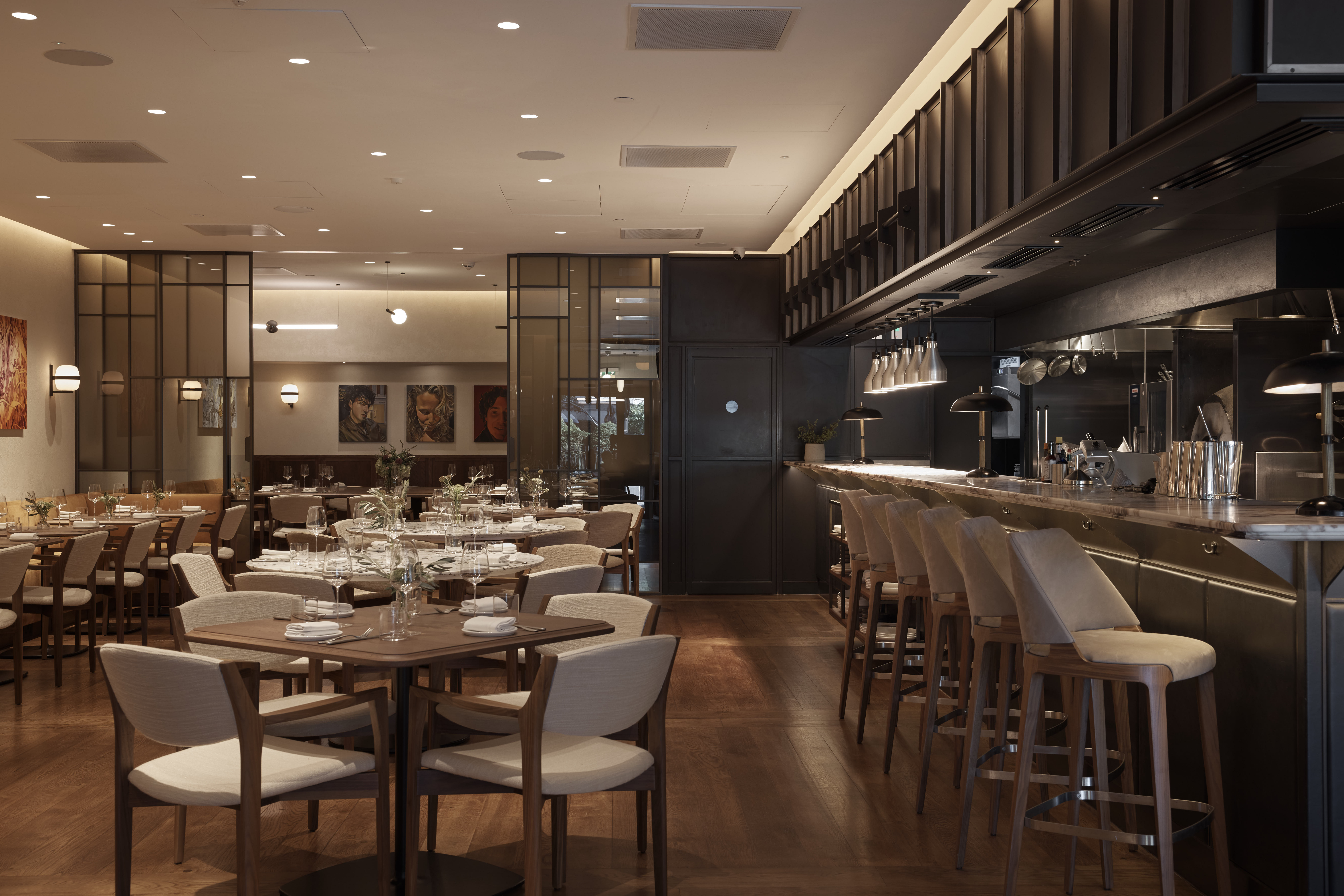 Modern restaurant with warm lighting, ideal for intimate dinners and corporate events.