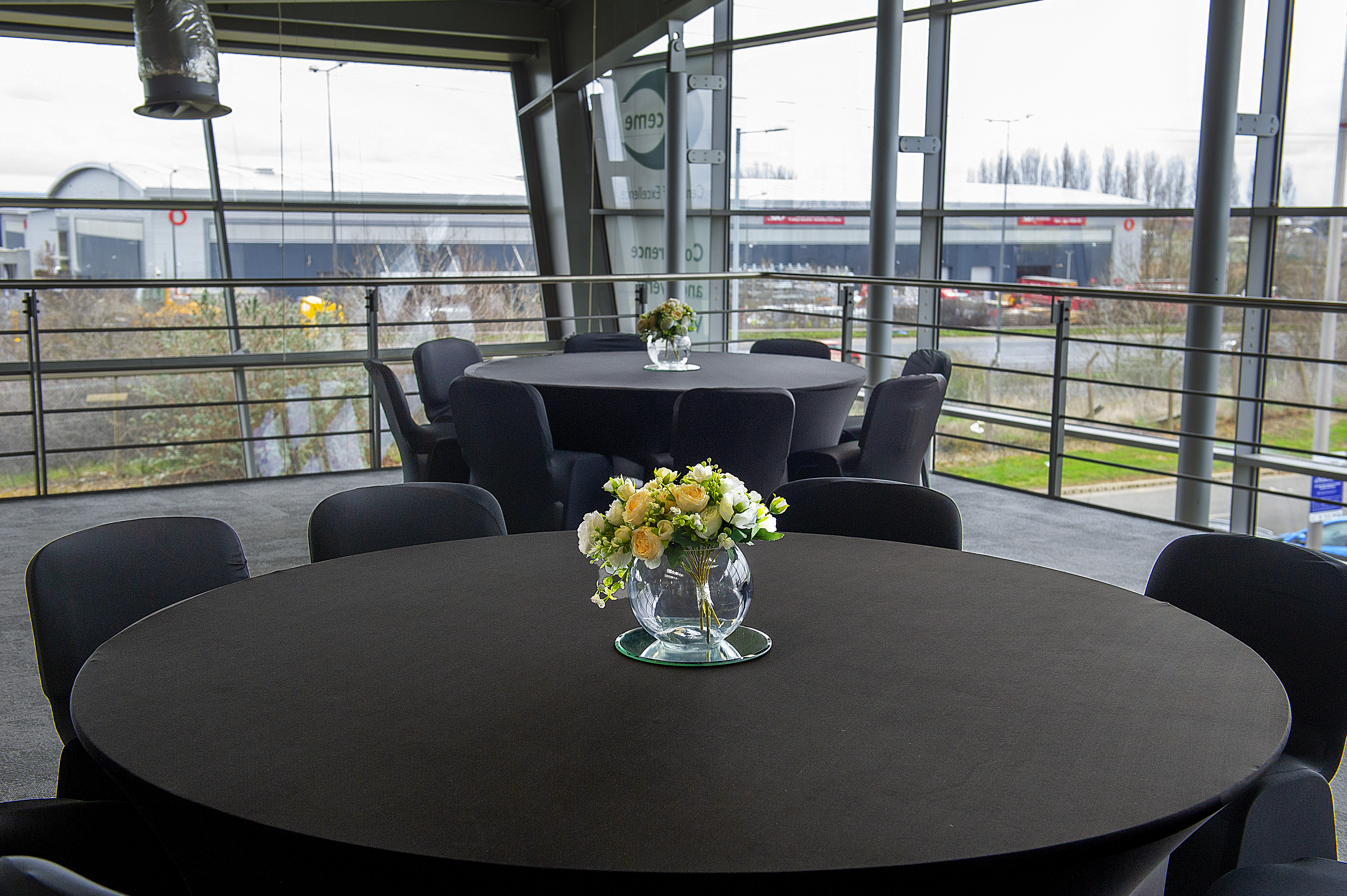 Elegant event space with round tables, ideal for corporate meetings and receptions.