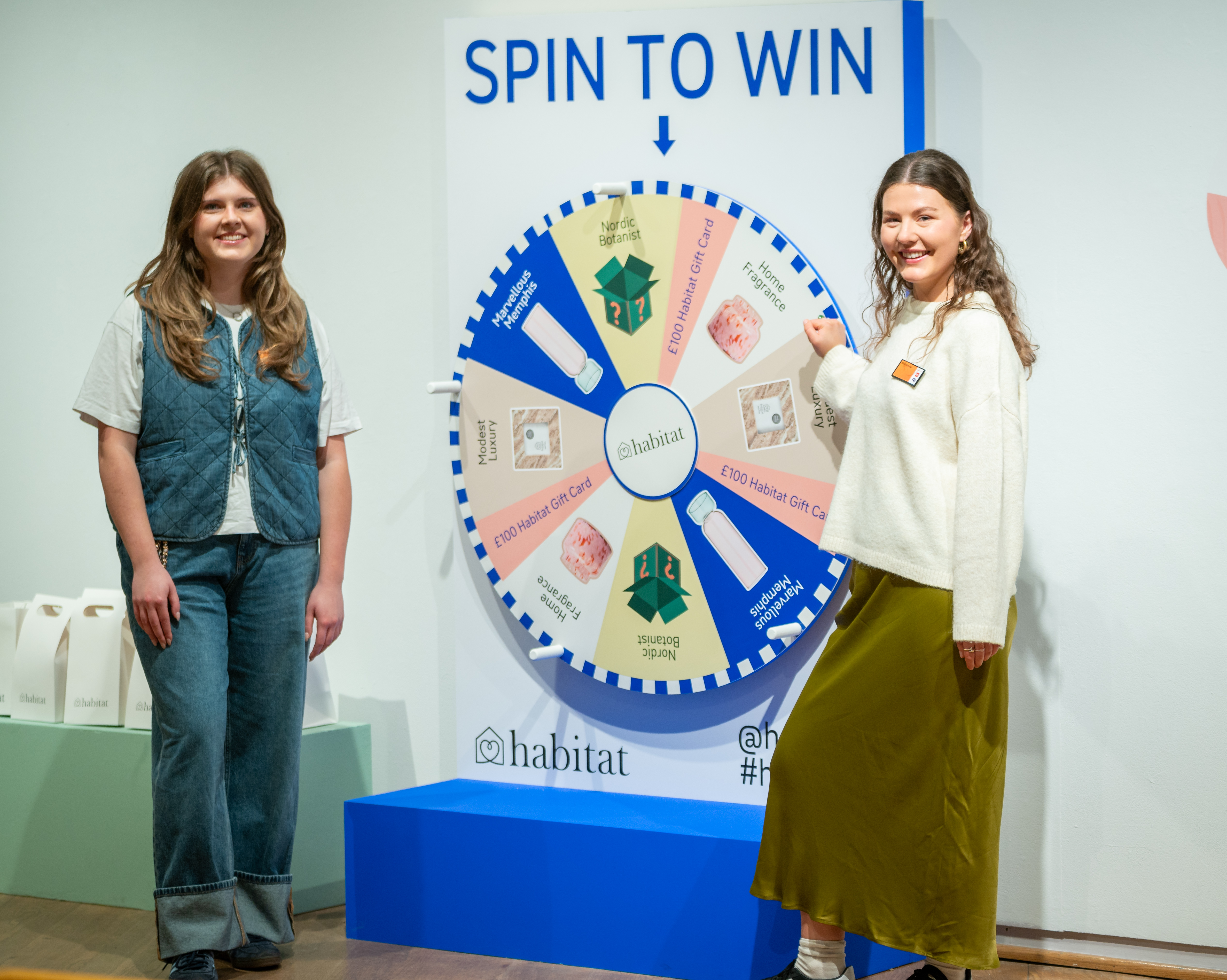 "Engaged attendees at a vibrant 'Spin to Win' wheel during a product launch event."