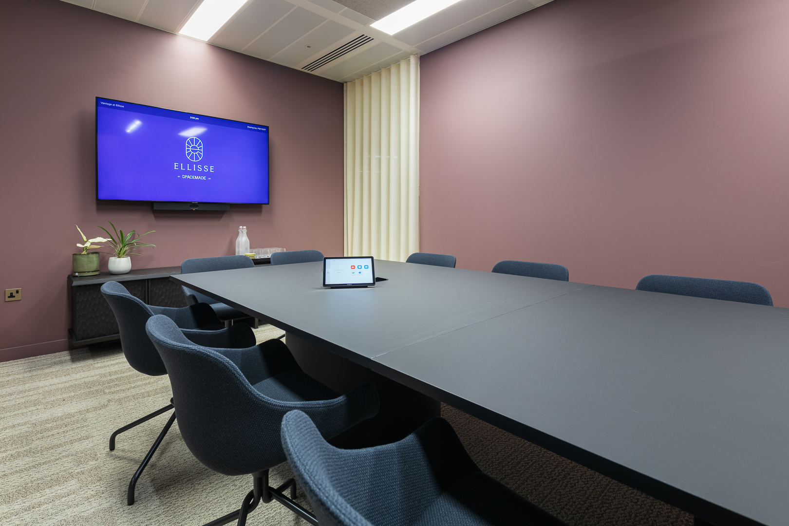 Modern huddle room for executive briefings and hybrid meetings with ergonomic seating.