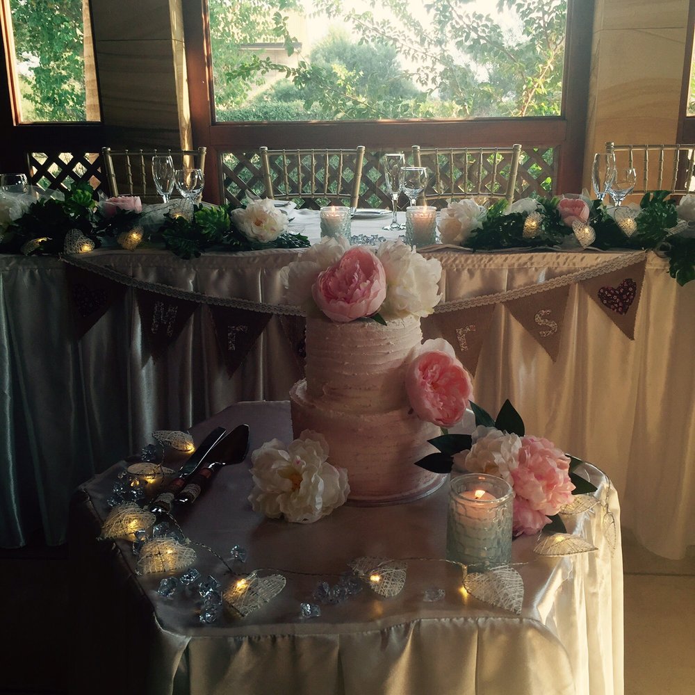 Wedding reception at Collaroy SLSC with elegant cake and romantic floral decor.
