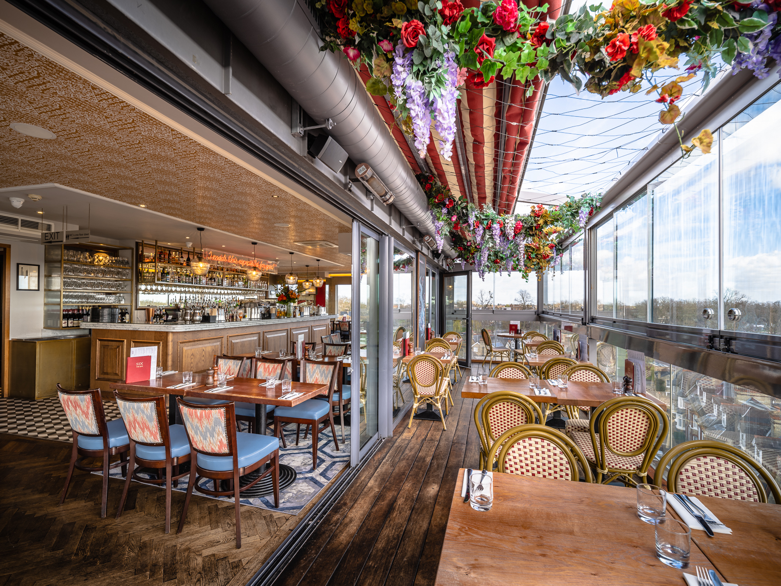 SIX Brasserie rooftop venue with floral decor, perfect for intimate events and gatherings.