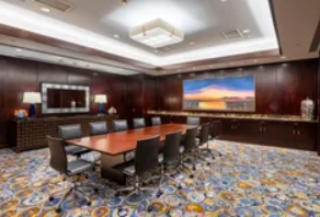 Sophisticated conference room with wooden table and leather chairs, ideal for meetings.