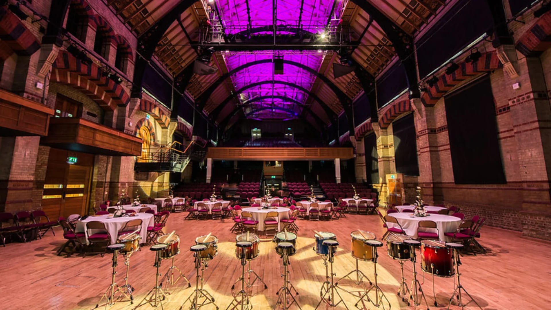 Schering Room at Cambridge Corn Exchange: Modern venue event setup with dramatic purple lighting.