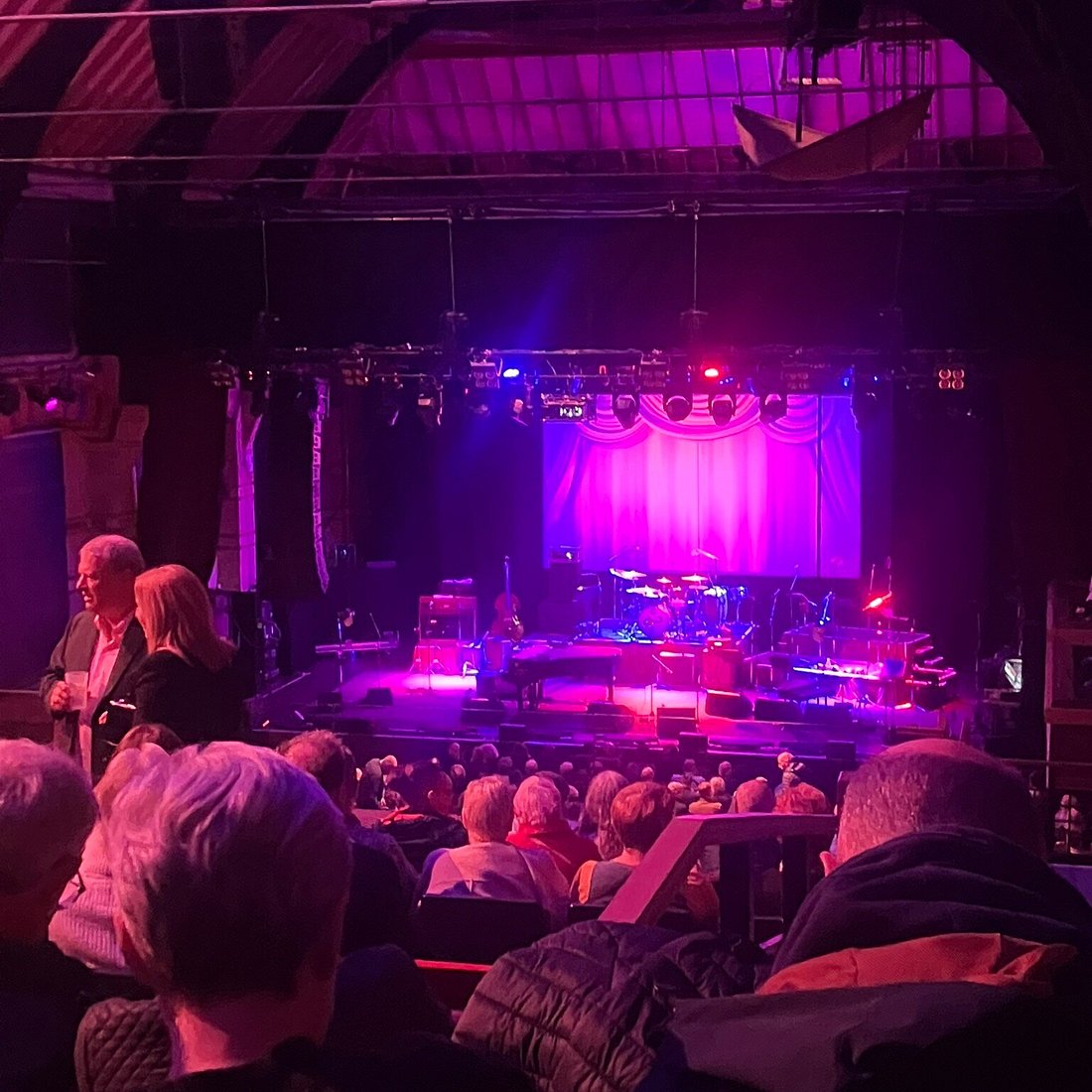 King's Room stage with magenta uplighting for live music concert venue event.