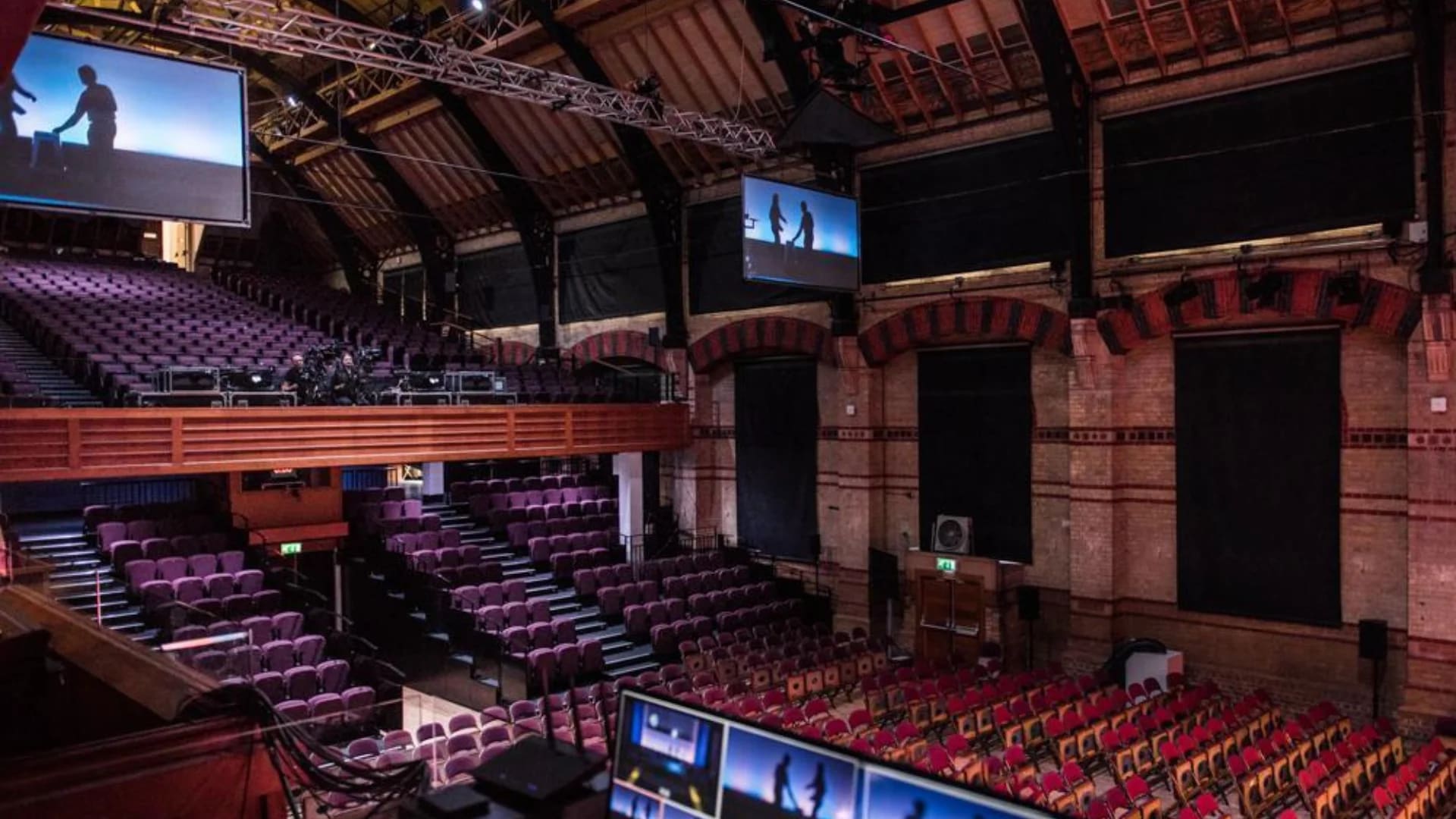 Cambridge Corn Exchange theater: tiered seating in a historic event venue for corporate conferences.