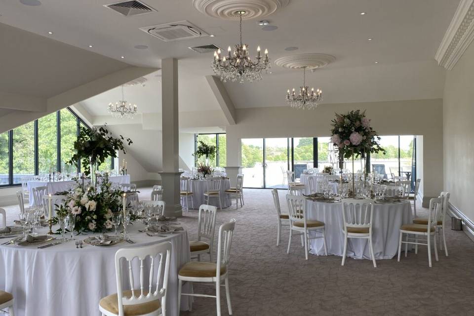 Elegant Royal Suite ballroom with floral centerpieces for luxury wedding and gala events.