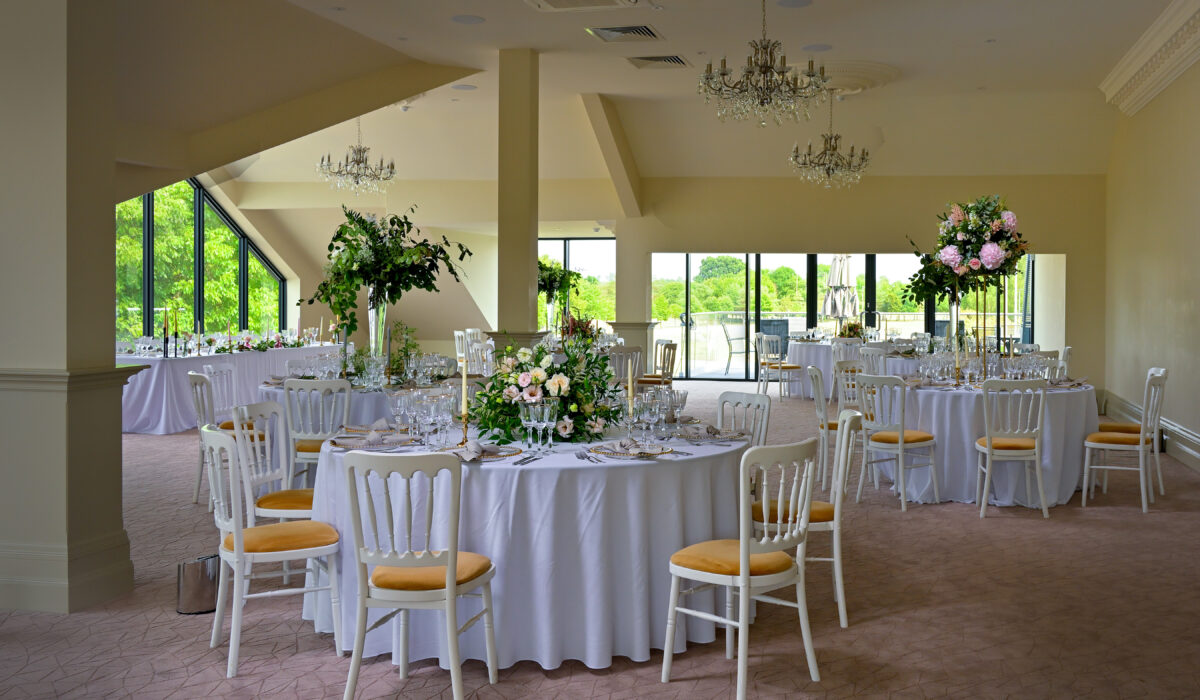 Royal Suite wedding setup at Cambridge Country Club with floral centerpieces and gilded chairs.