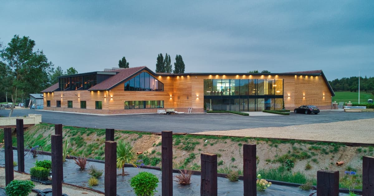 Modern Garden Suite at Cambridge Country Club with glass walls, ideal for weddings and retreats.