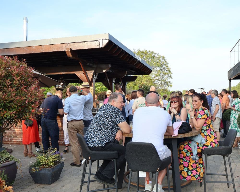 Outdoor networking reception at Cambridge Country Club with high-top seating for corporate events.