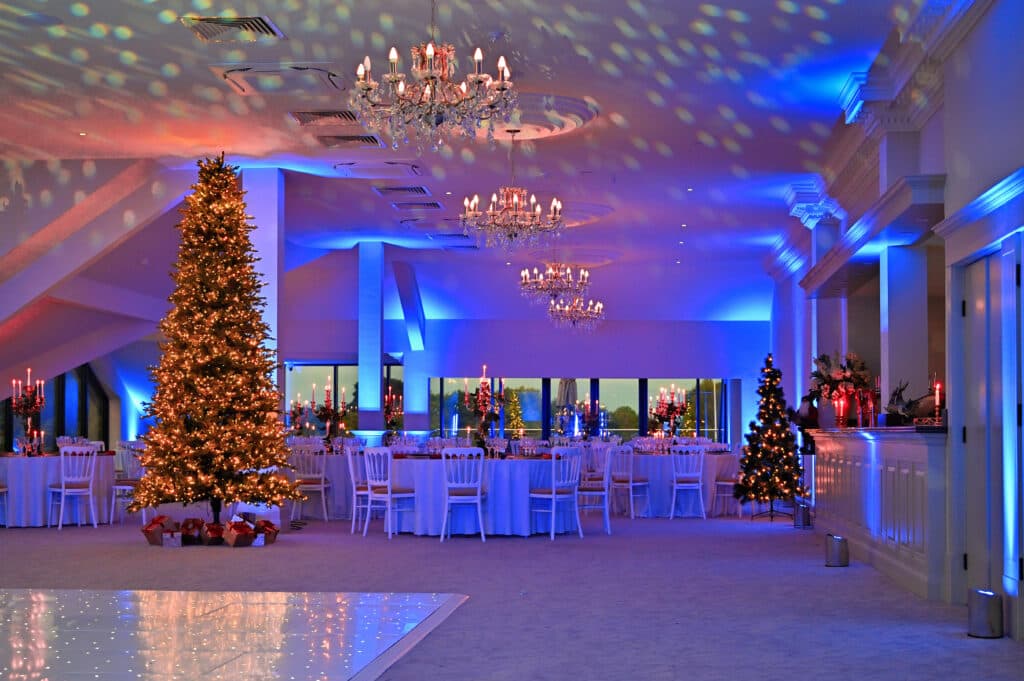 The Terrace ballroom at Cambridge Country Club with festive gala lighting and holiday decor.