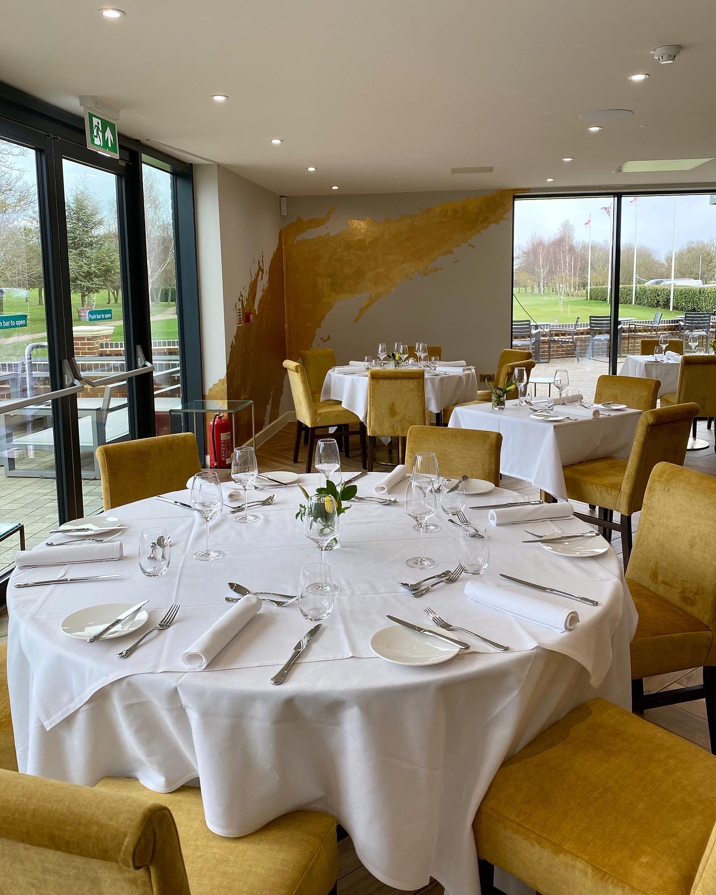 The Terrace at Cambridge Country Club with mustard velvet seating for corporate and social events.