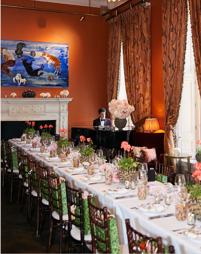 Elegant dining setup with floral centerpieces at The Arts Club London event.