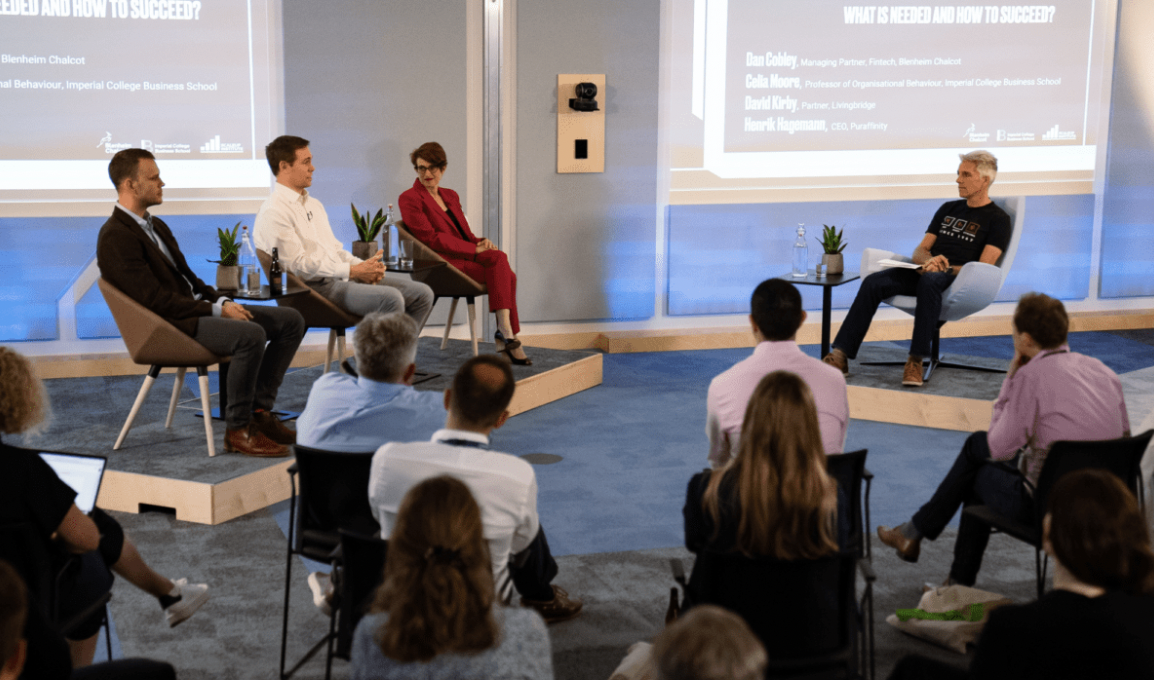 Panel discussion at The Arena, engaging speakers, industry insights, vibrant event setting.