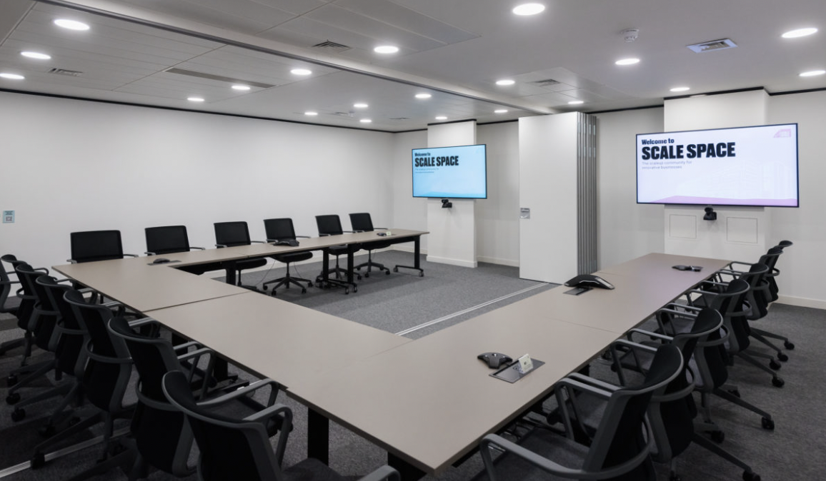 Modern conference room in Scale Space with oval table, ideal for meetings and presentations.