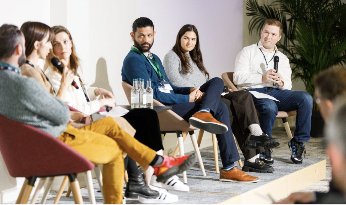 Panel discussion at The Arena in Scale Space, engaging speakers, conference dialogue