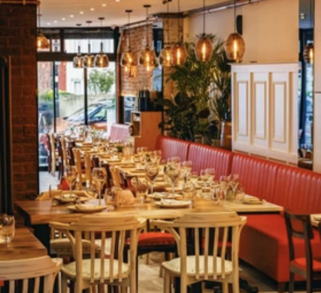Stylish dining space with red leather seating at Luna Llena Restaurant for events.
