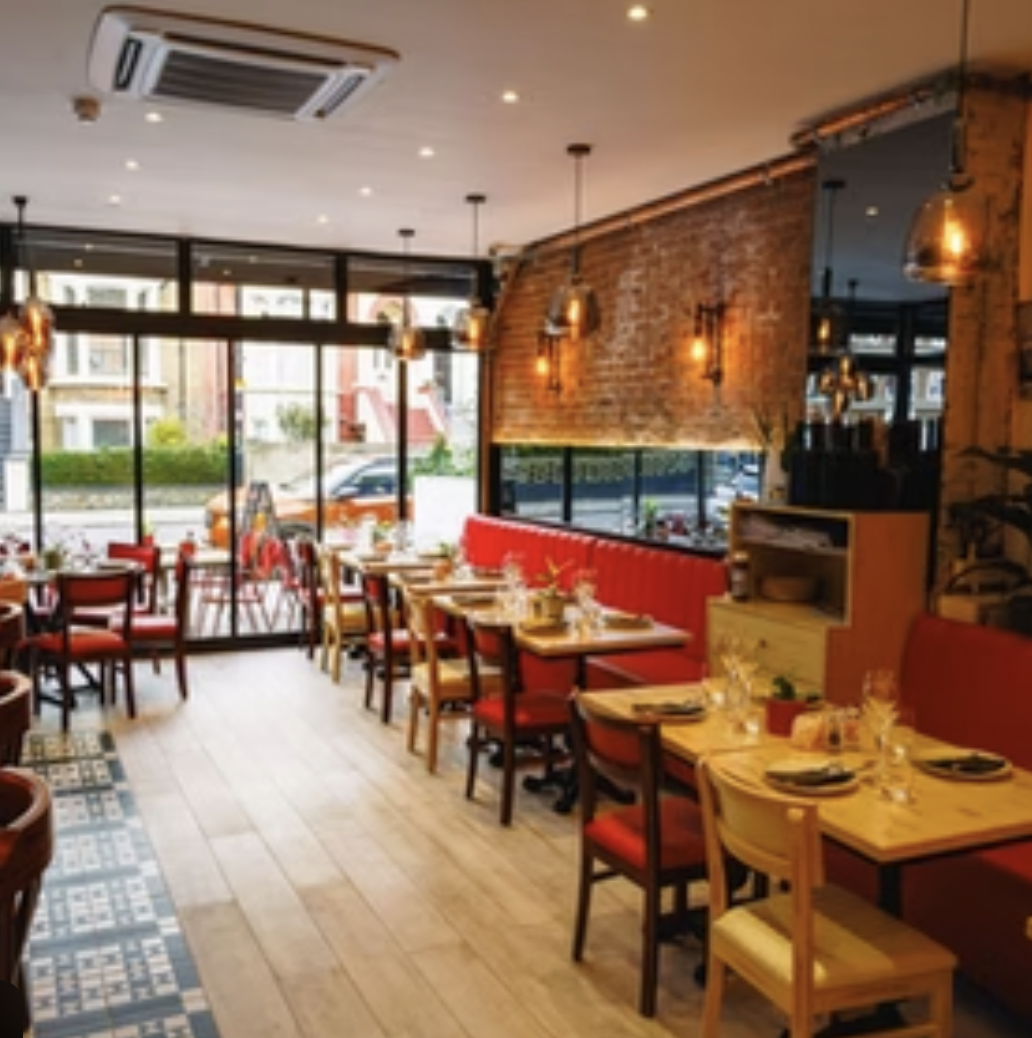 Cozy Luna Llena Restaurant with red leather banquettes, perfect for intimate gatherings.