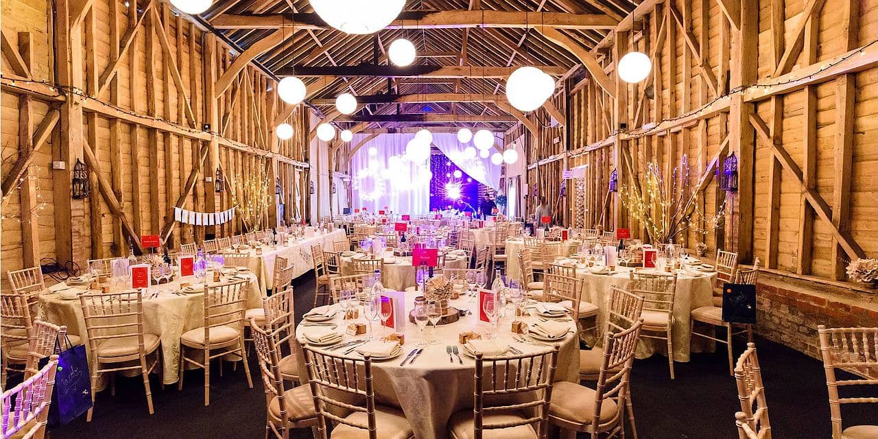 Rustic-chic barn wedding venue at Childerley Hall featuring ambient globe lighting.