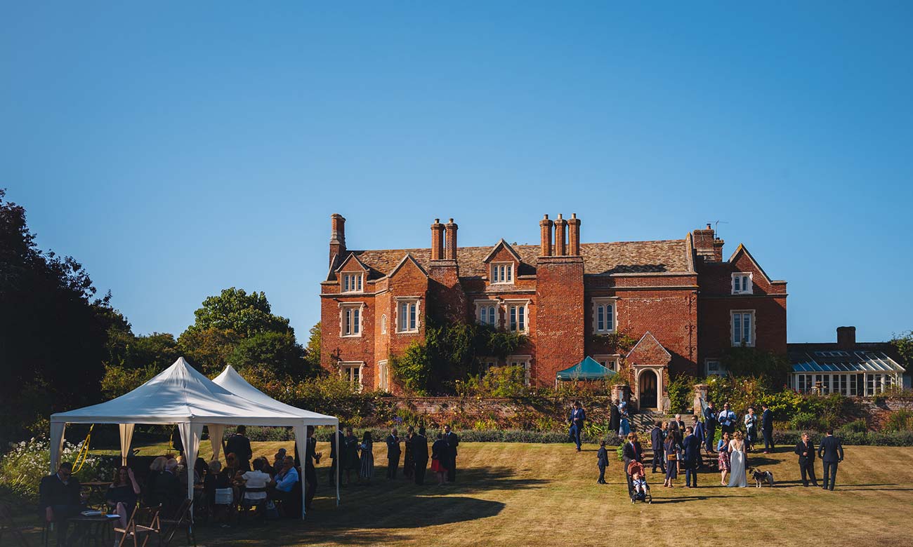 Outdoor garden reception at Childerley Hall featuring a structured event tent for weddings.