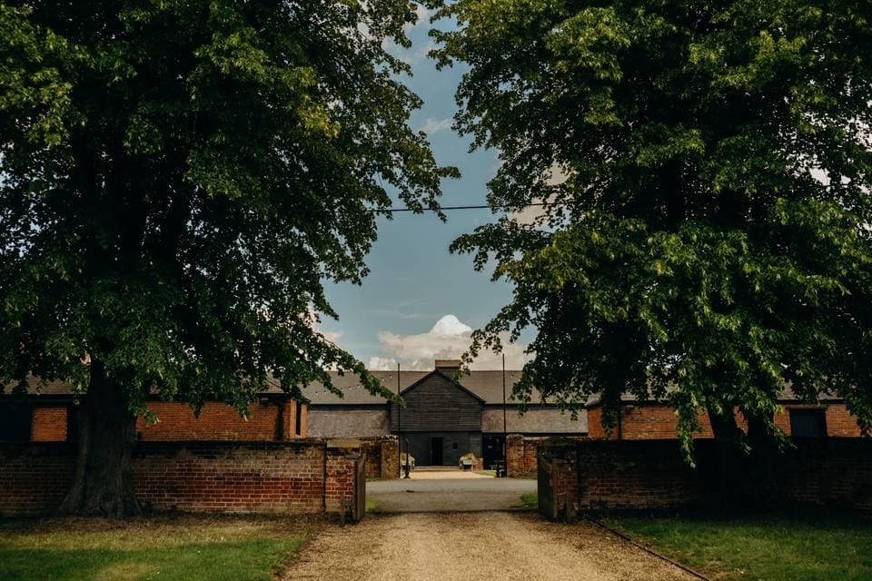 Childerley Hall adjoining courtyard: rustic wedding venue and outdoor retreat space.
