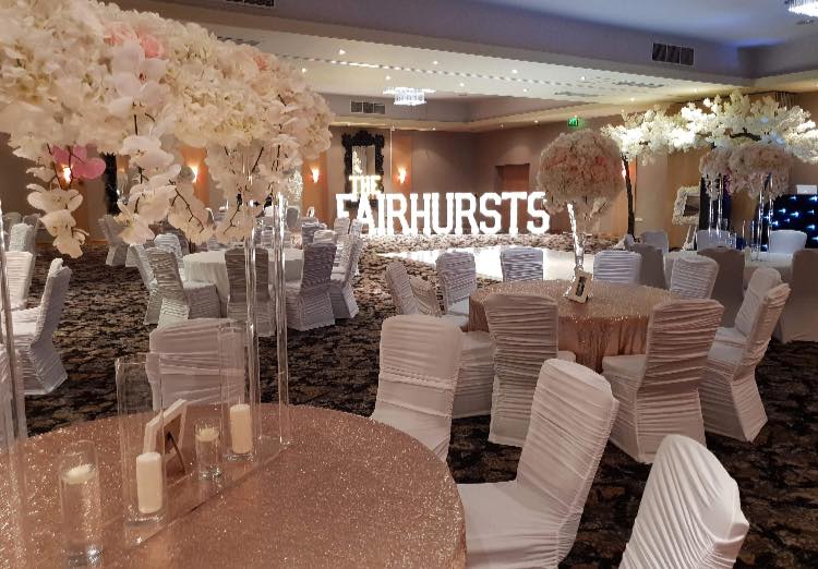 Elegant wedding venue with floral arrangements and sequined decor for celebrations.