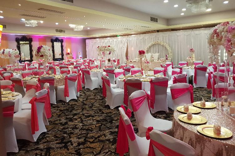 Elegant banquet hall with pink décor, perfect for weddings and special events.
