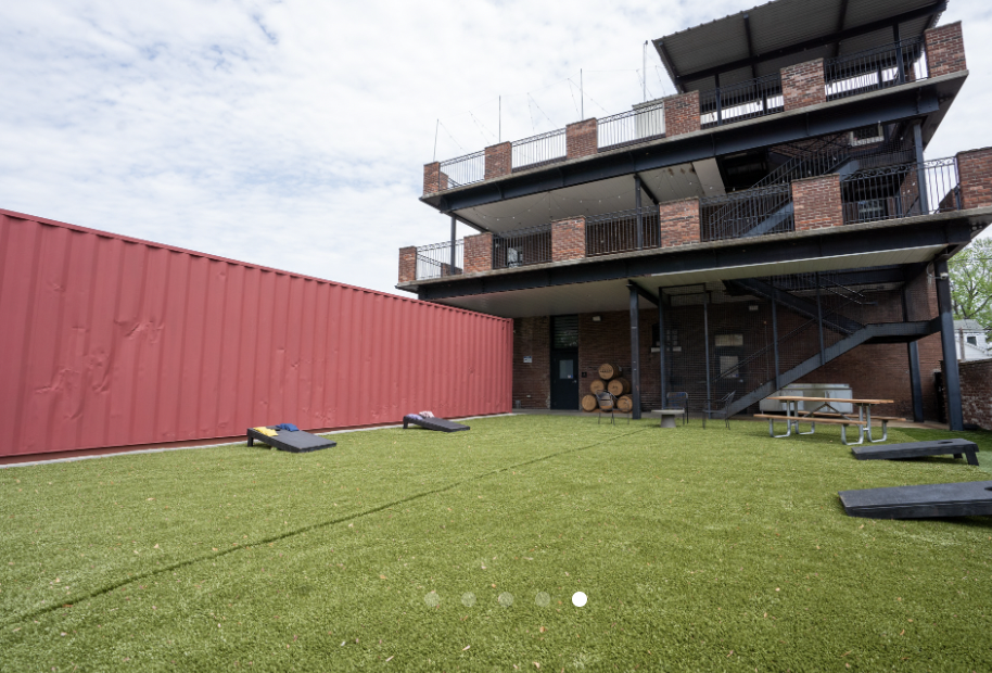 Outdoor event space at The Swepson Guesthouse with artificial turf for gatherings.
