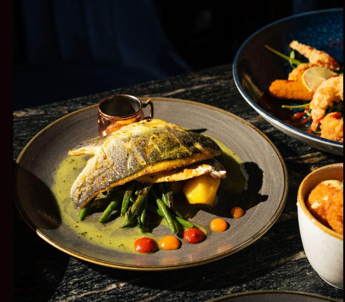 Elegant fish dish with asparagus at Fire&Ice event celebration. Culinary artistry for events.