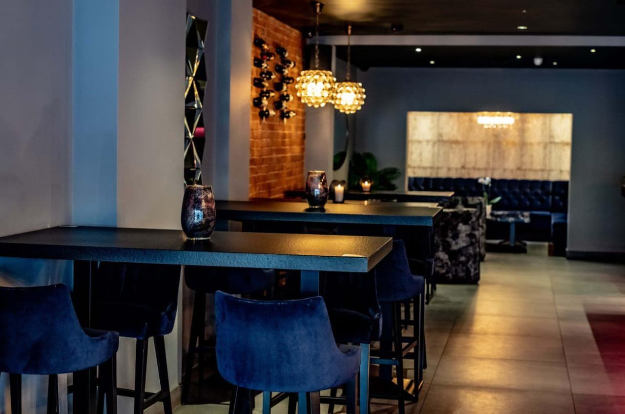 Stylish Fire&Ice event space with sleek high-top tables for modern gatherings.