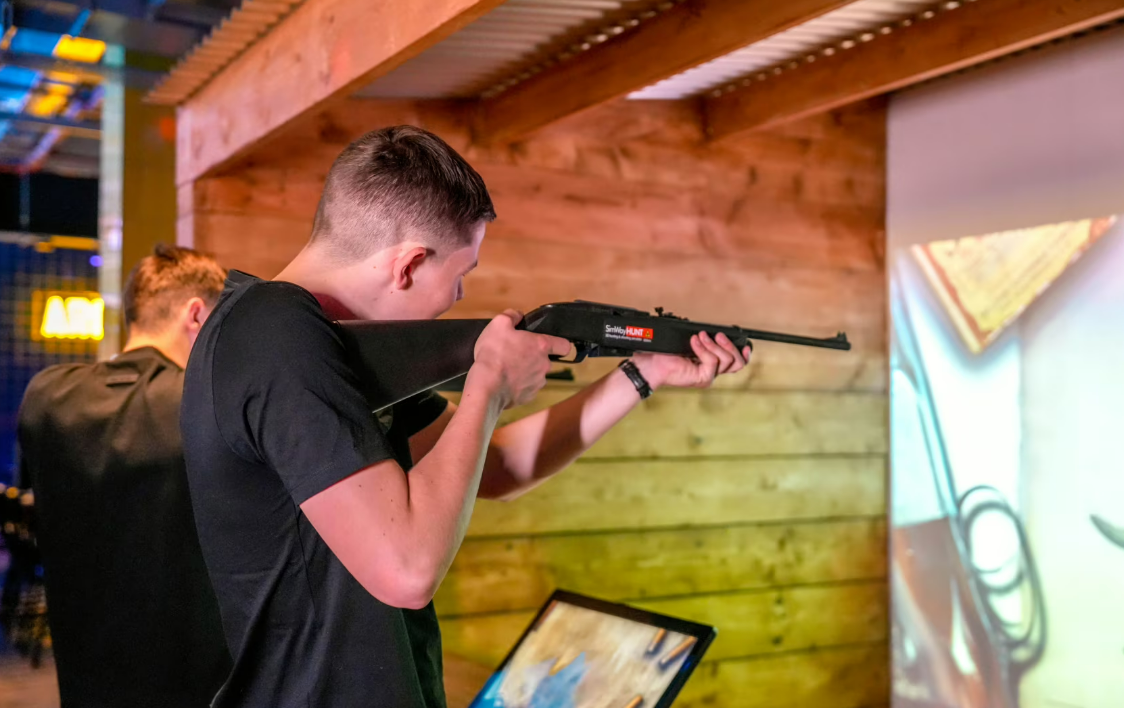 Interactive shooting simulation at The Head To Head Zone, team-building event in Glasgow.