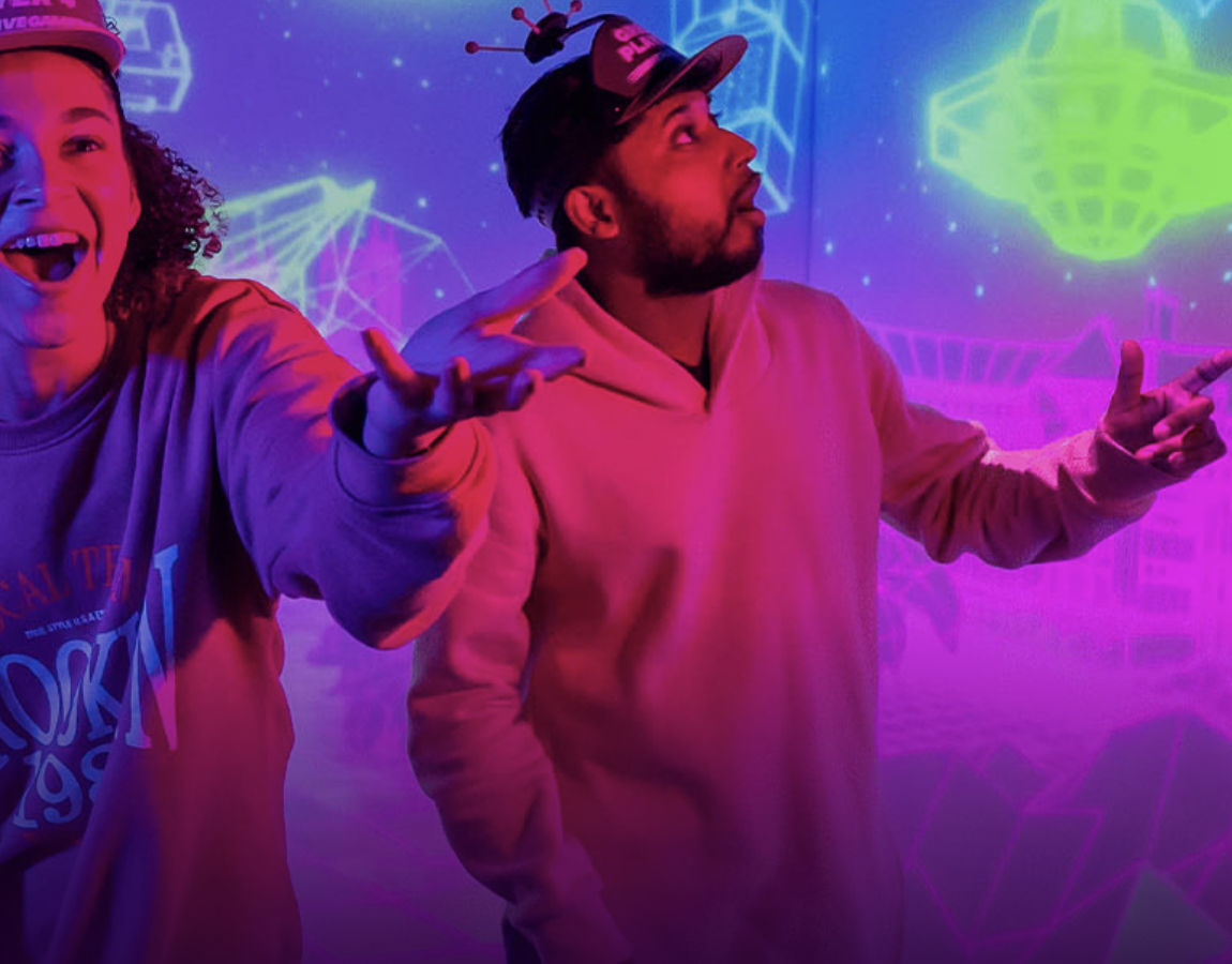 "Immersive Gamebox London venue hire with vibrant neon backdrop for engaging events."