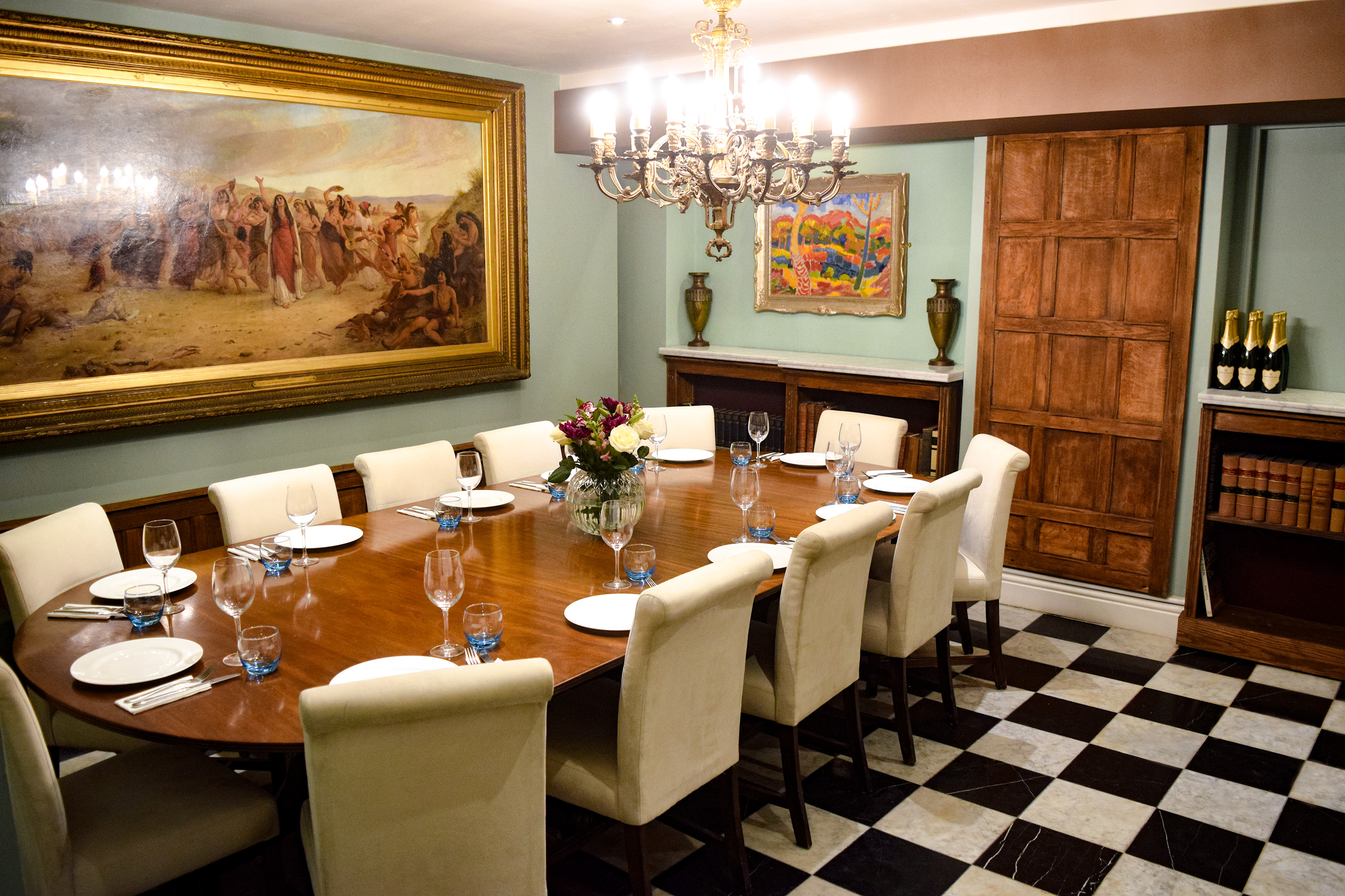 Elegant private dining room with checkered floors, ideal for boardroom meetings and upscale events.