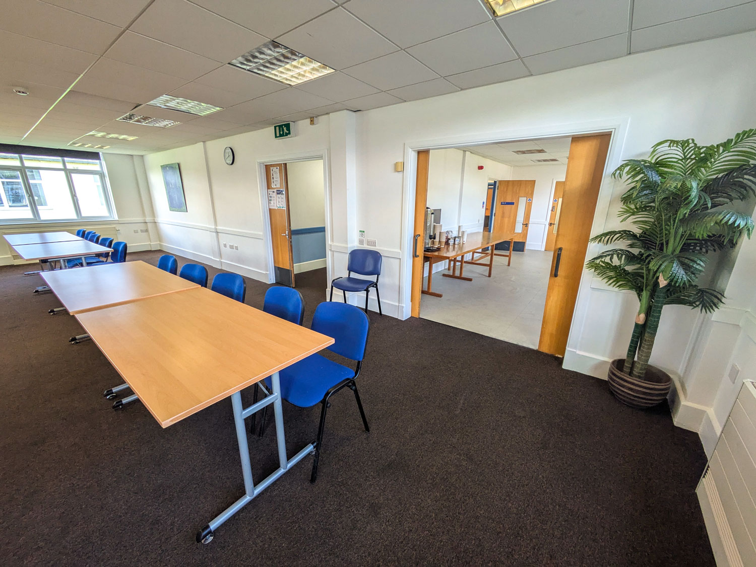 David Baker Room at Vassall Centre: bright meeting space with long table and blue chairs.