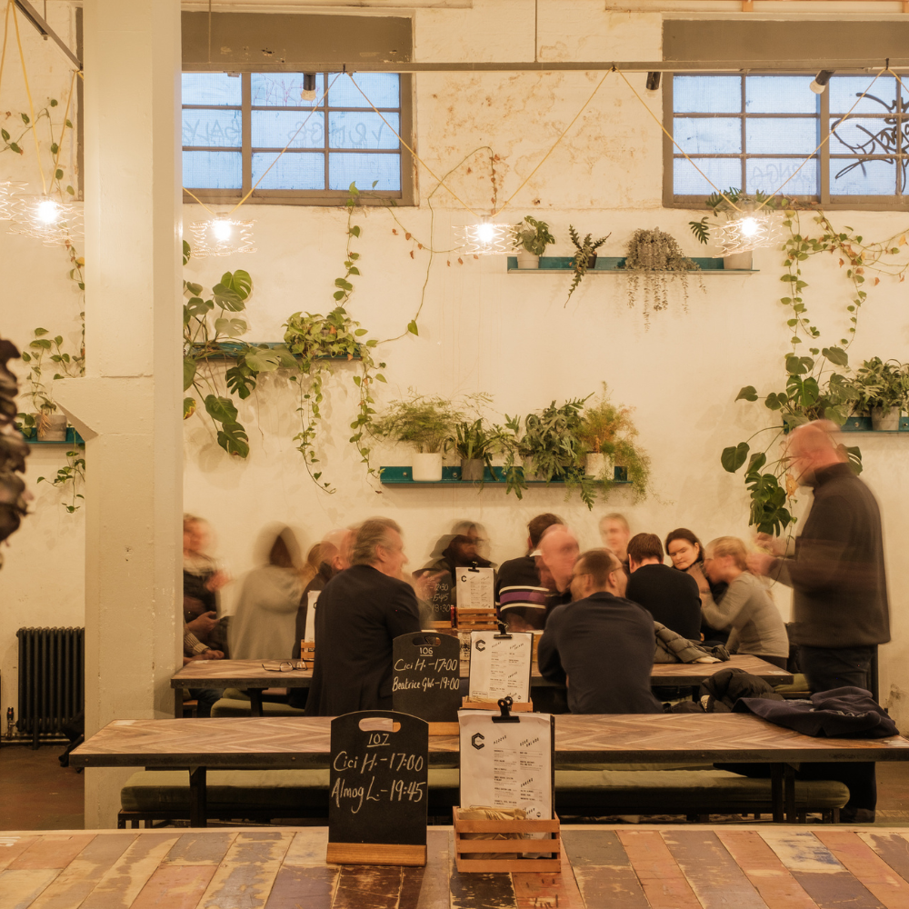CRATE Brewery event space with communal seating for networking and casual corporate functions.