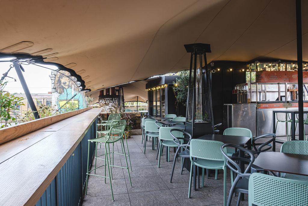 Covered rooftop terrace at The Lord Napier Star with built-in bar, ideal for networking events.