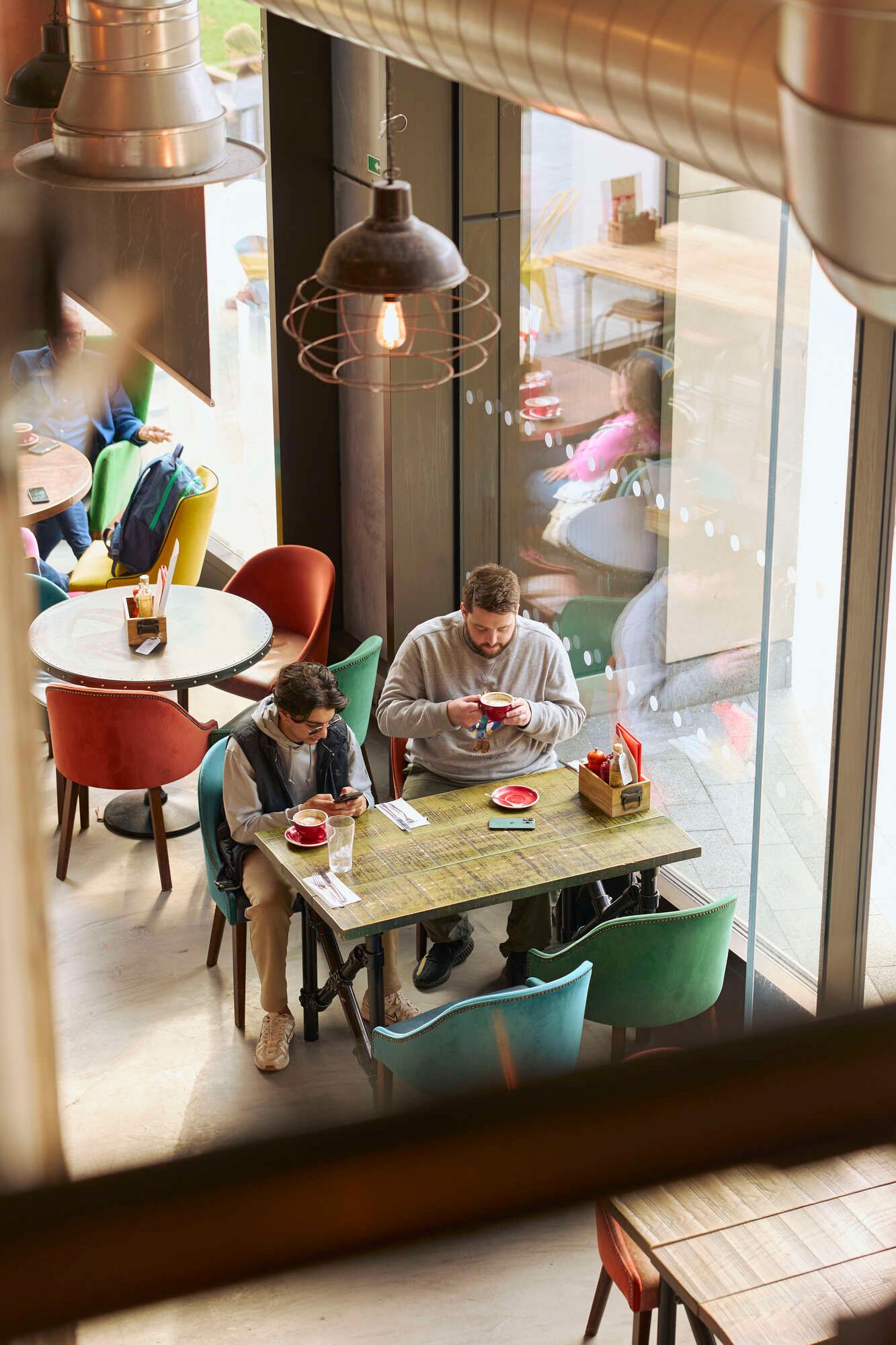 Cozy café with colorful chairs, perfect for informal meetings and networking events.