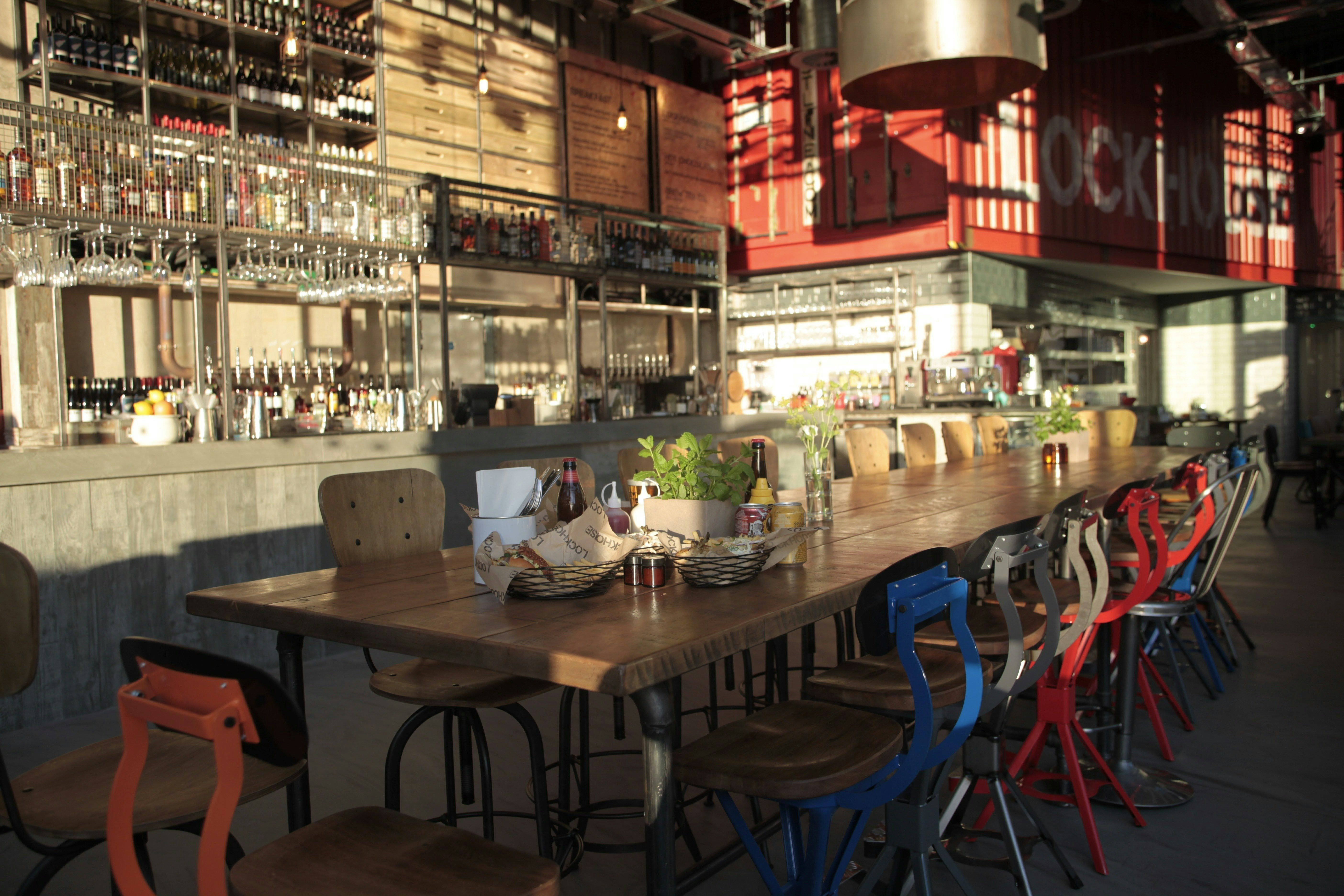 Spacious venue with wooden table, vibrant chairs for events and gatherings in Lockhouse