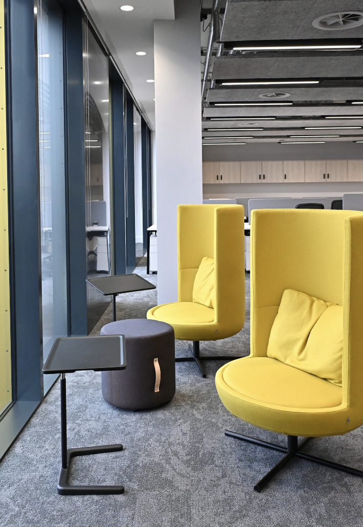 Modern seating area with vibrant yellow chairs in PHTA for collaborative meetings and events.