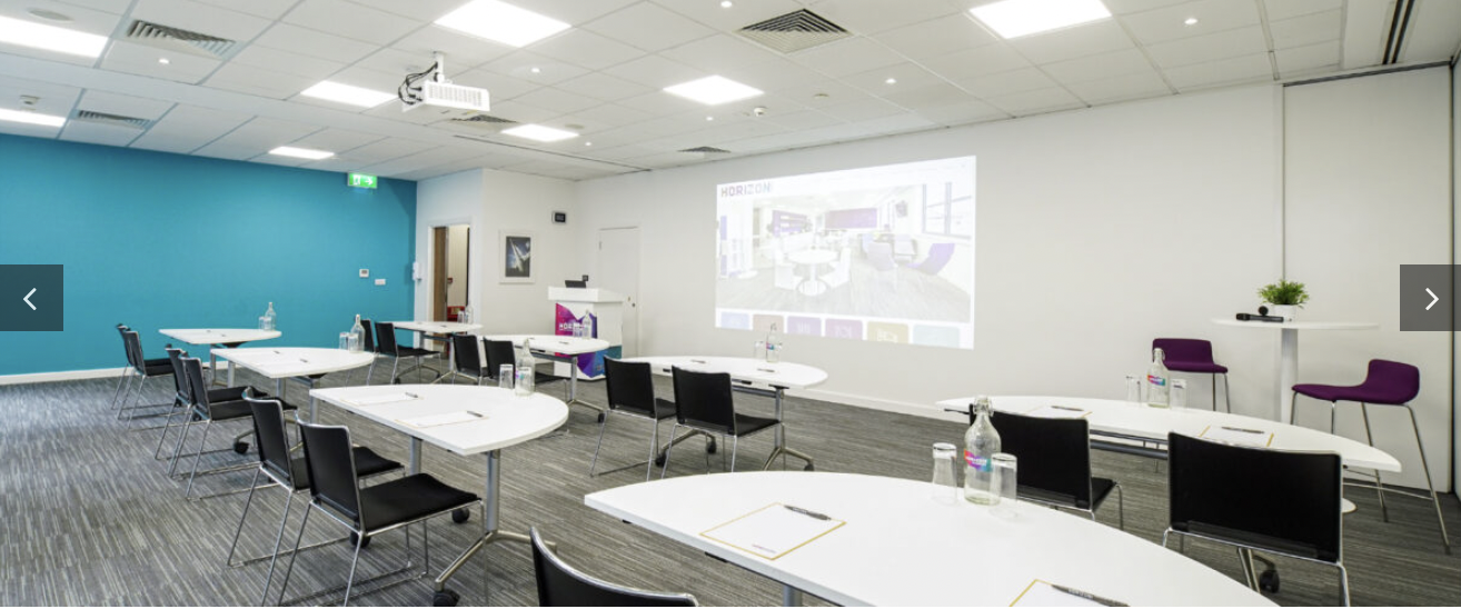 Modern meeting room in Horizon Leeds with round tables for collaborative events.