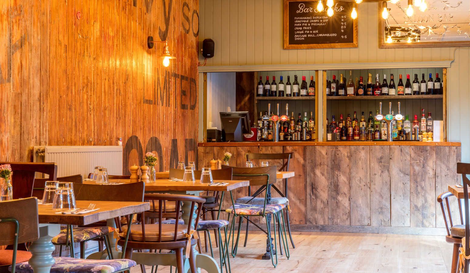 Rustic dining room with wooden tables, ideal for intimate gatherings and casual events.