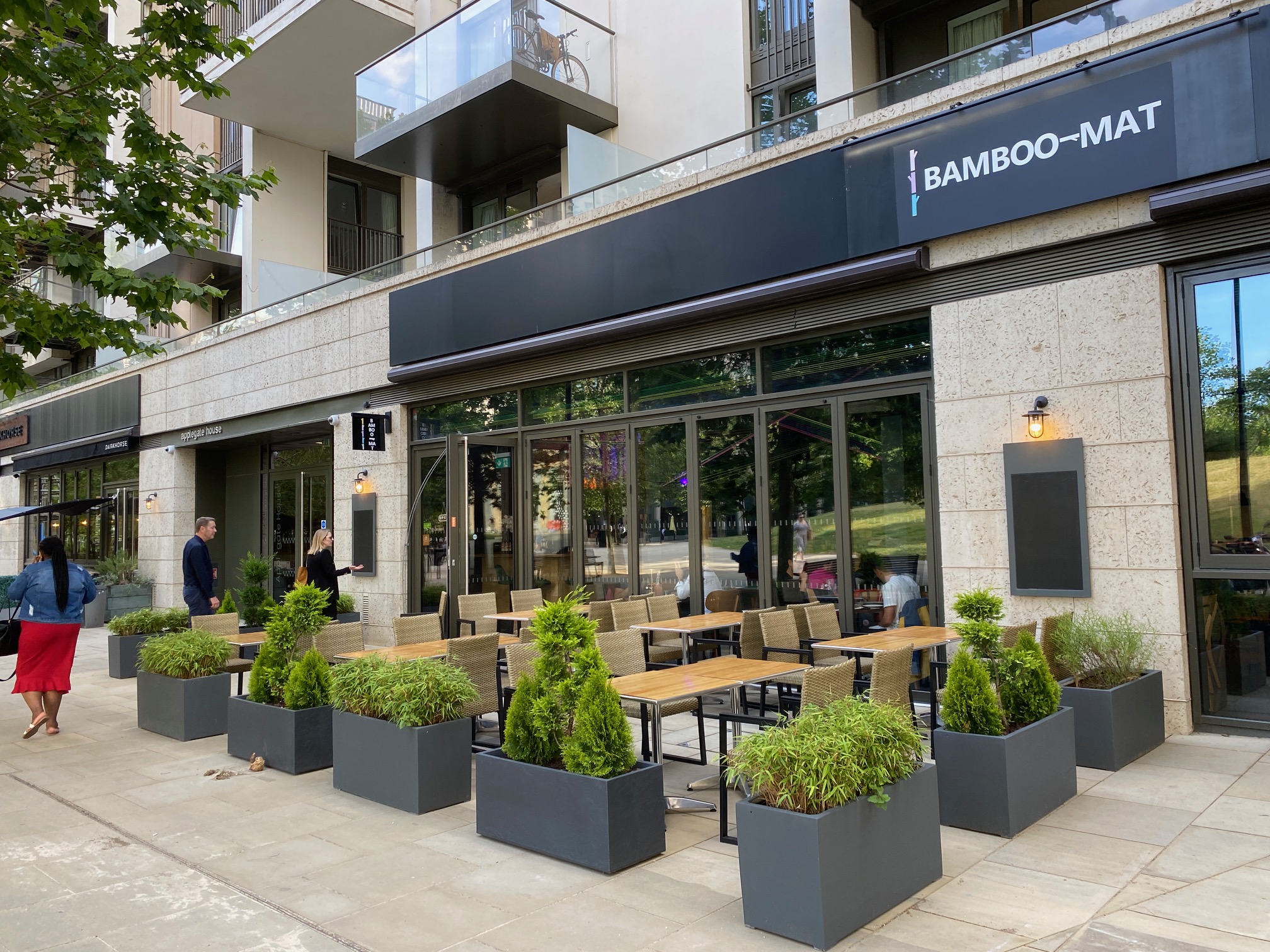 Modern outdoor restaurant venue with terrace seating, perfect for events and gatherings.