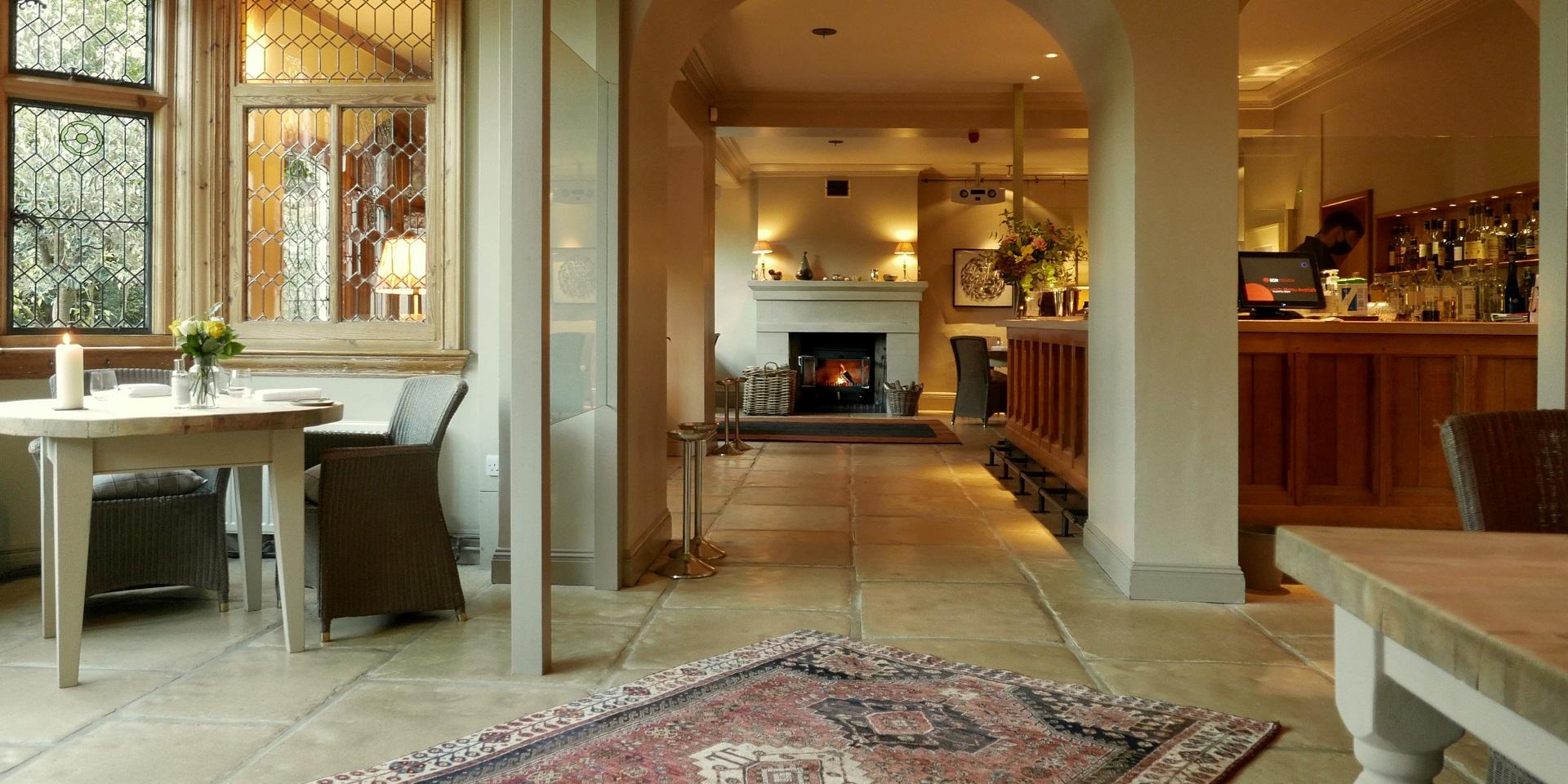 Welcoming Downstairs Dining Room with fireplace for intimate gatherings or networking events.