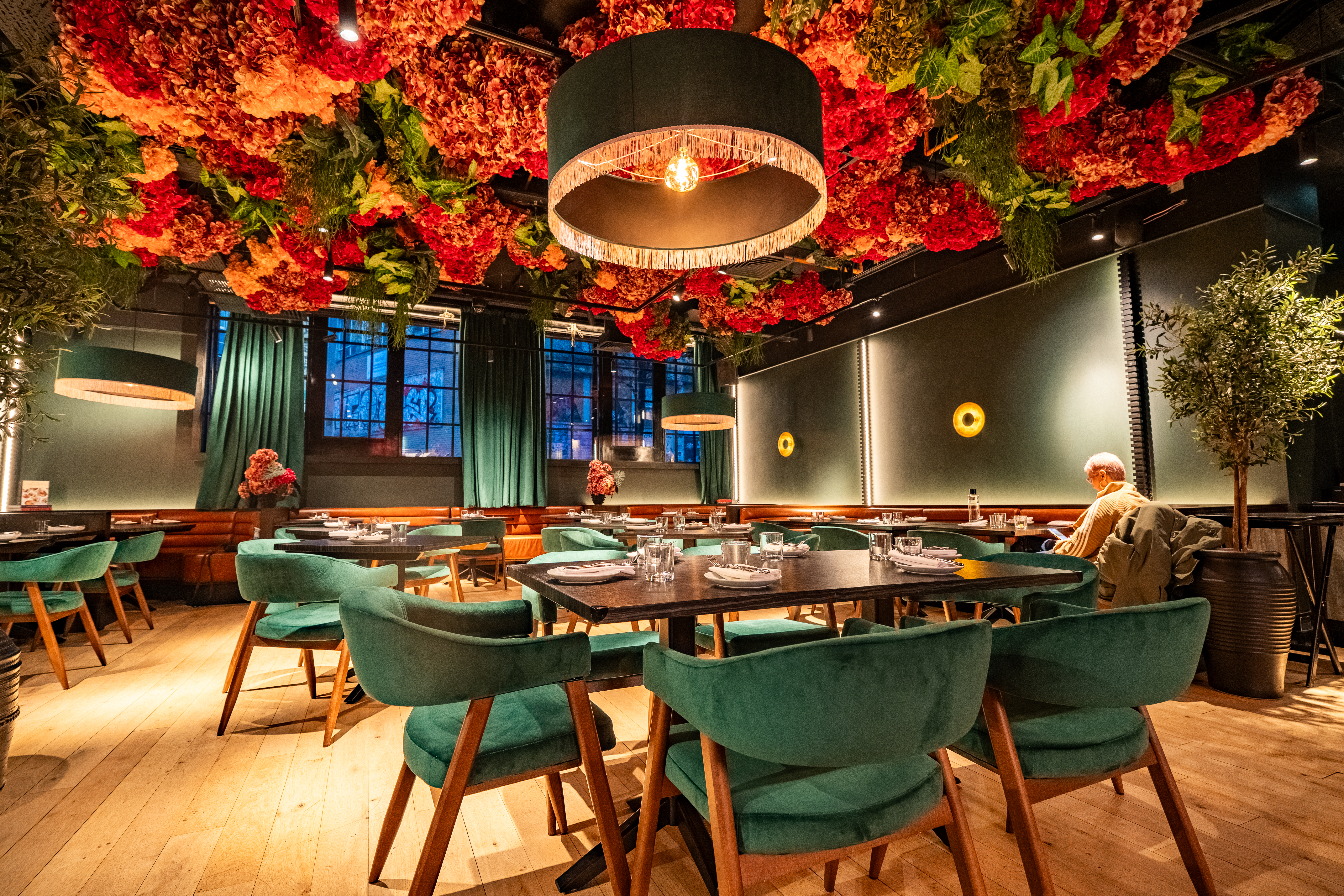 Vibrant restaurant with floral ceiling, perfect for intimate gatherings and events in London.