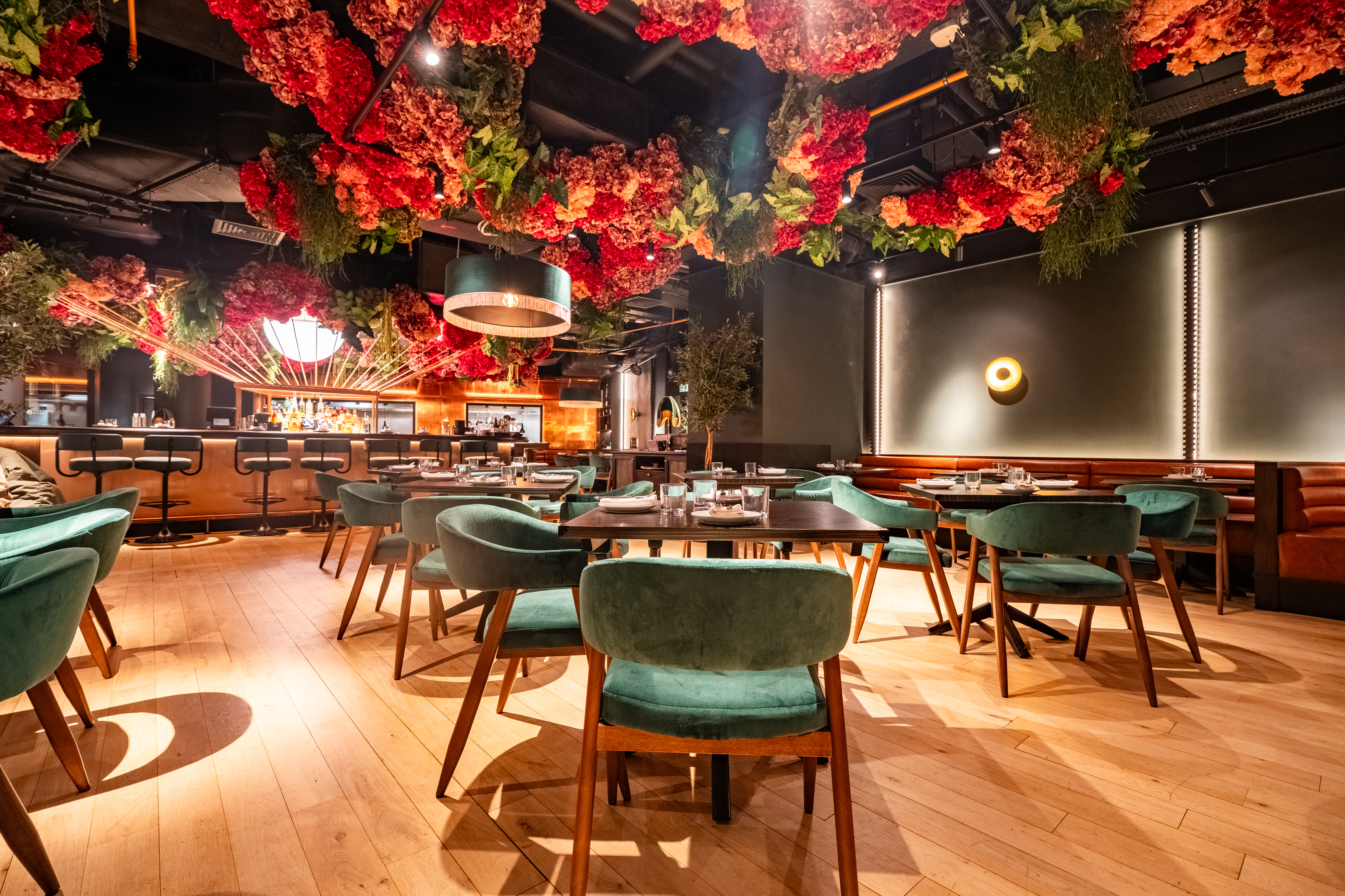 Stylish restaurant with floral ceiling, ideal for intimate dinners and networking events.