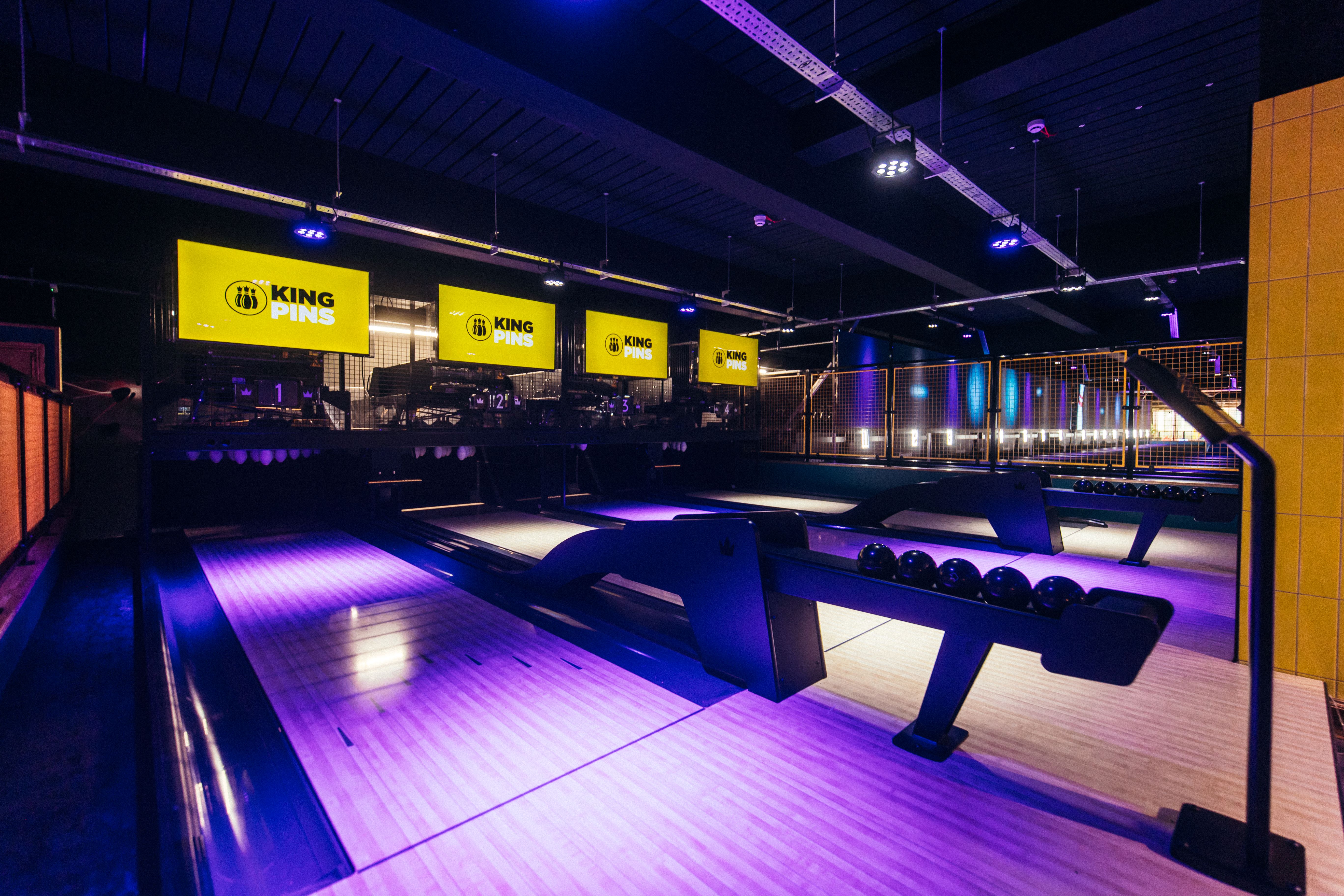 Modern bowling venue with vibrant lighting for corporate events in Belfast.